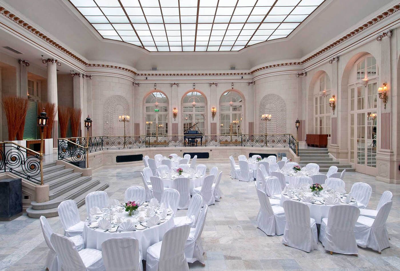 White wedding dinner in grand high ceiling room