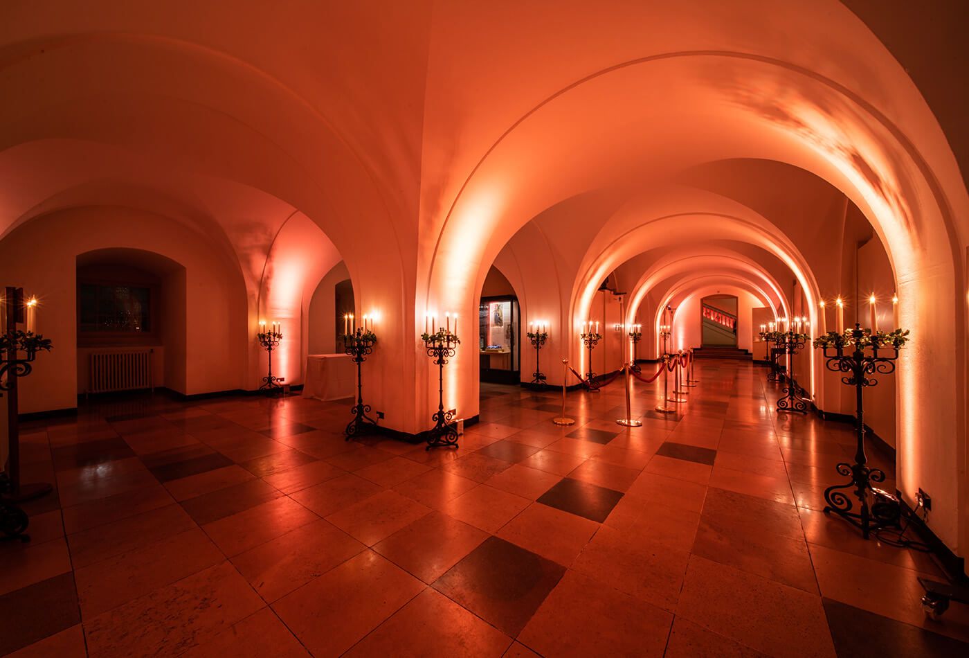 Underground event, arched ceilings and lit entirely with candle stands
