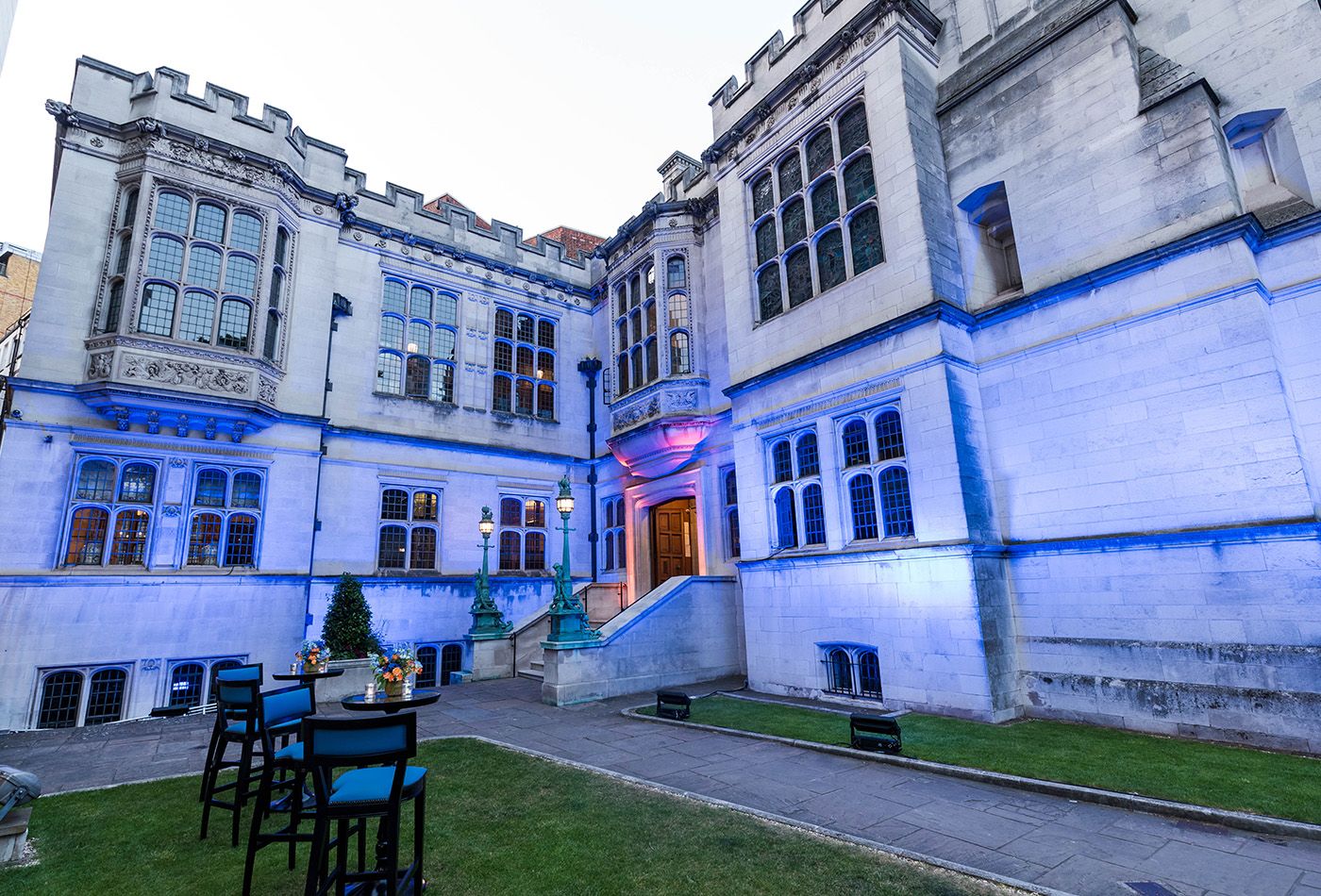 Neo-Gothic mansion lit up in blue