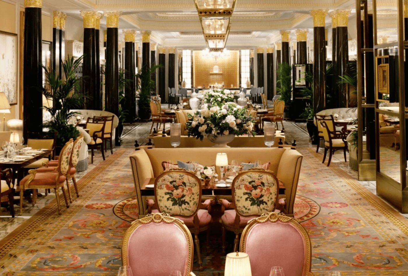 Traditional lounge area with black pillars and golden and pink theme