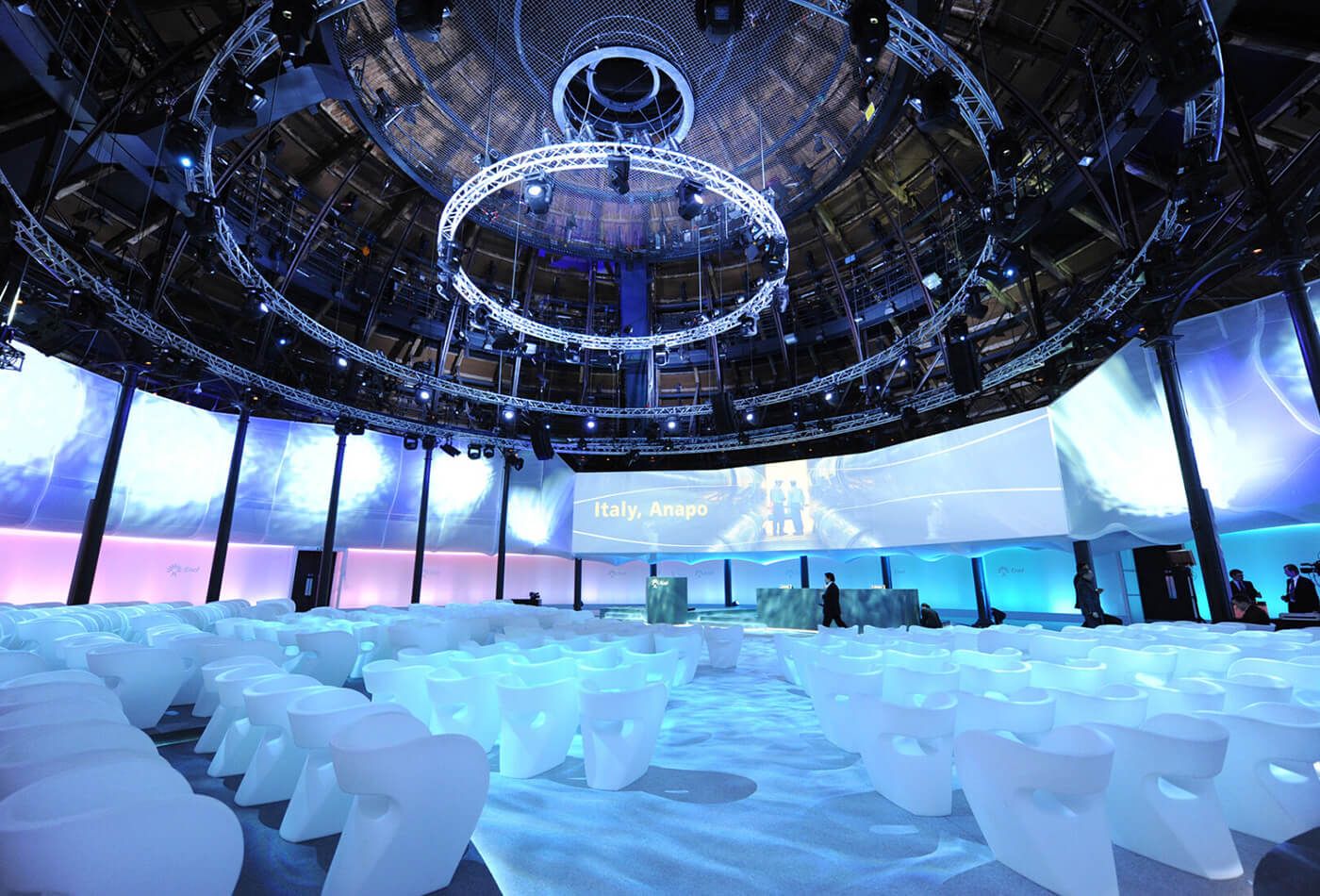 Vast circular conference space with white seating and high ceilings
