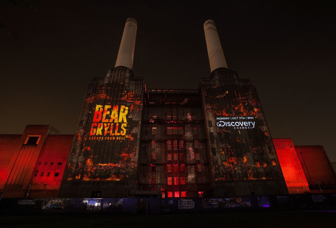 Exterior shot, lit up in red with advertising projected onto building.jpg