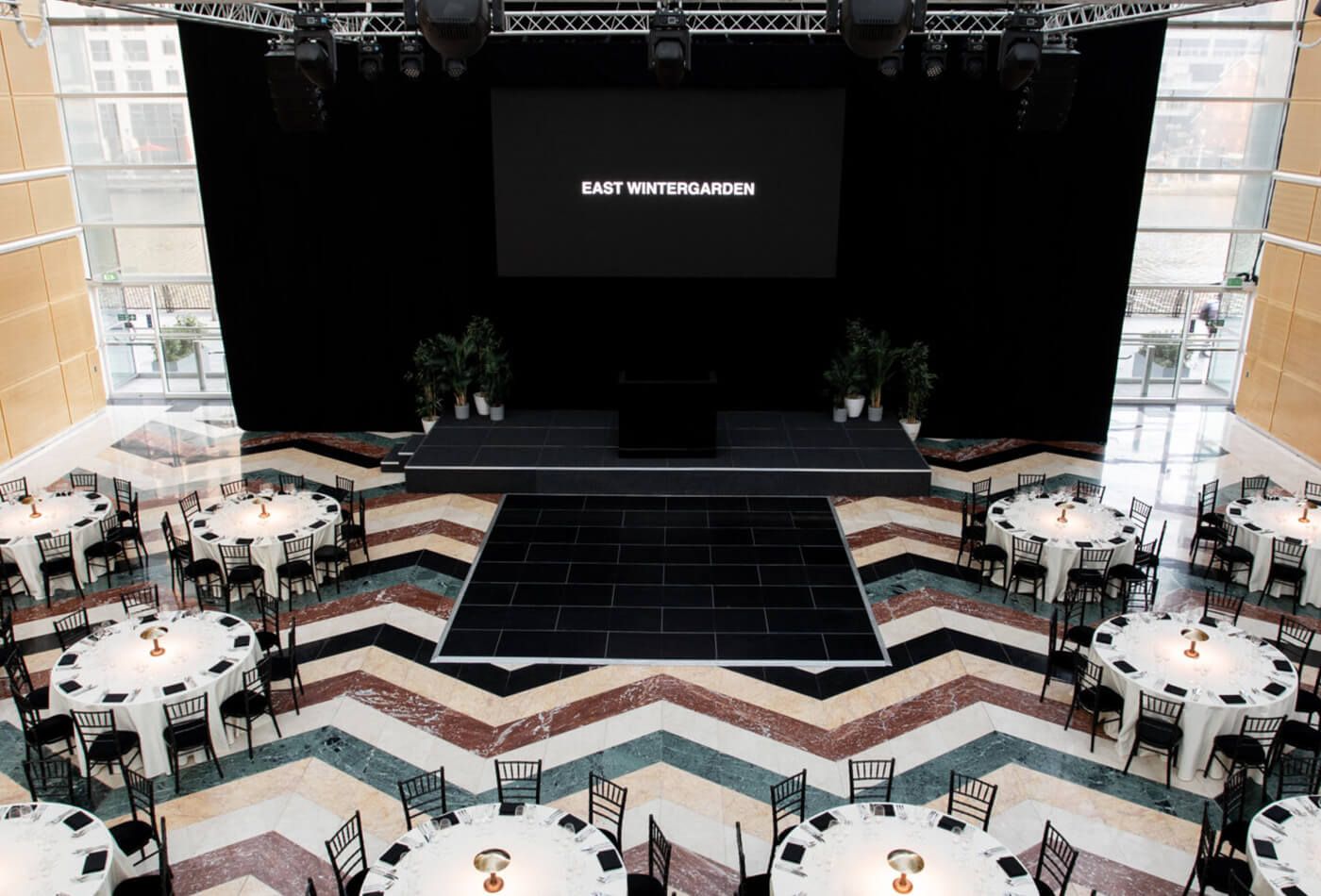 East winter garden showcase, round tables and large stage