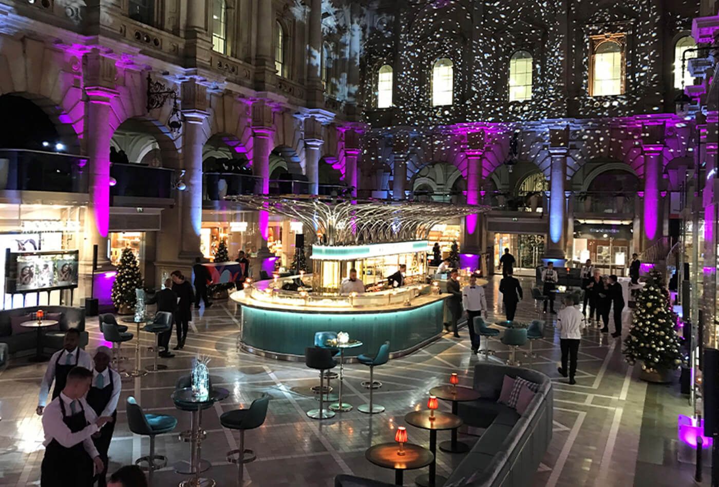 Courtyard and bar lit up in purple and turqouise