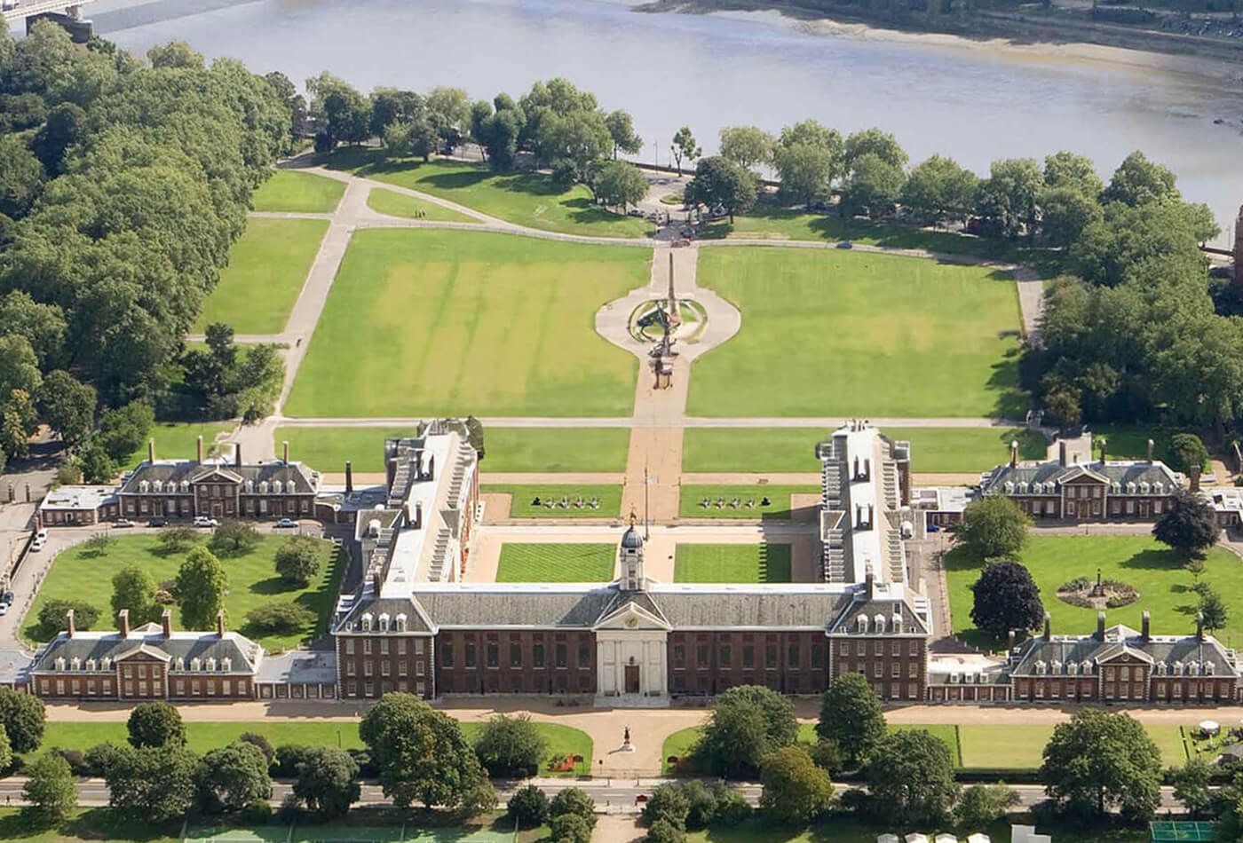 Birds eye view of grand building, green gardens and parks